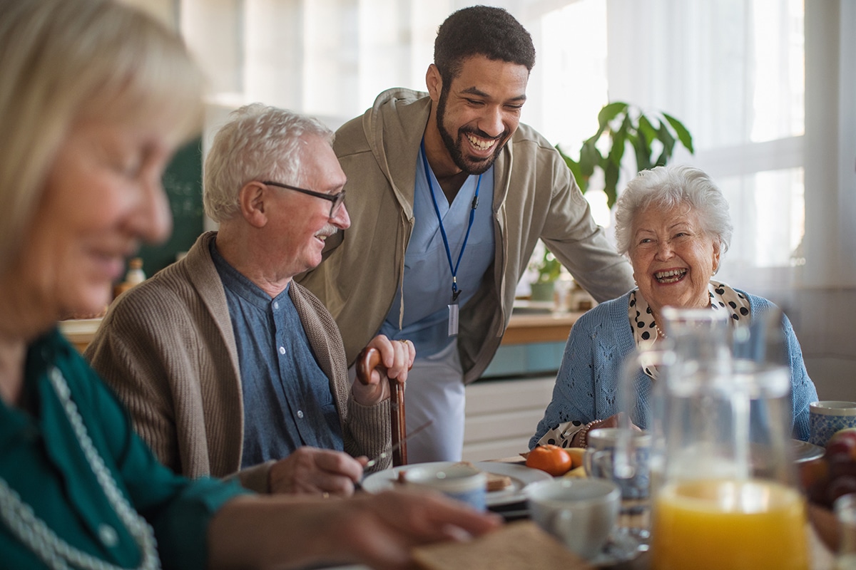 PACS-300x200-food1 Group of cheerful seniors enjoying breakfast in nursing home care center.