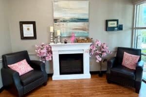 Fireplace and chairs in front lobby at Cherrywood Post Acute